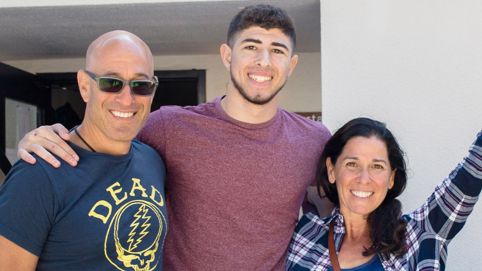 Student with parents smiling